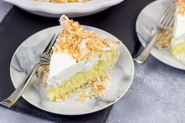 Topped with lightly toasted coconut flakes, this Coconut Cream Pie is a classic summer dessert!  Grab a fork and dig in!