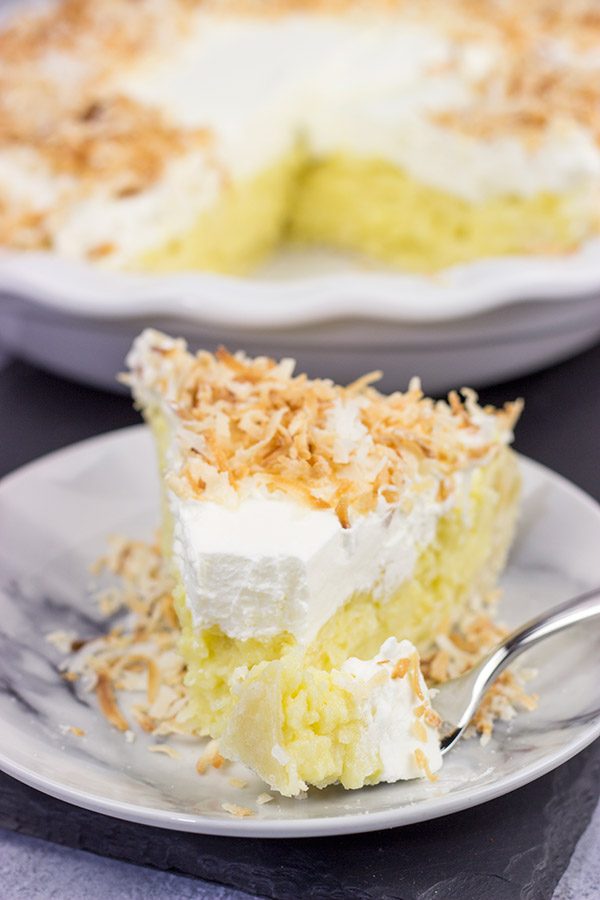 Topped with lightly toasted coconut flakes, this Coconut Cream Pie is a classic summer dessert!  Grab a fork and dig in!