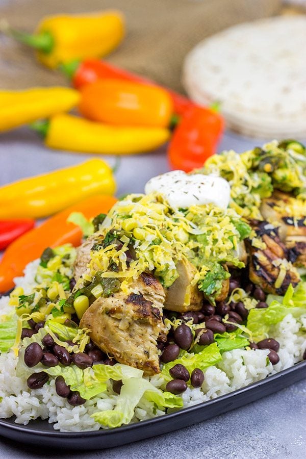 Looking for a delicious and fun recipe to grill this weekend?  Put these Grilled Jerk Chicken Burrito Bowls on the menu!