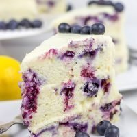 This Lemon Blueberry Cake is what happens when a muffin runs smack into the side of a cake! Featuring muffin-like layers of cake topped with lemon cream cheese frosting, this dessert is mighty tasty!