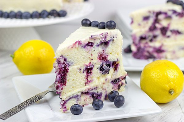 This Lemon Blueberry Cake is what happens when a muffin runs smack into the side of a cake!  Featuring muffin-like layers of cake topped with lemon cream cheese frosting, this dessert is mighty tasty!