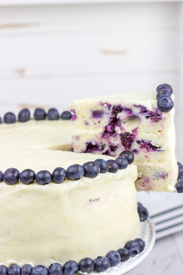 This Lemon Blueberry Cake is what happens when a muffin runs smack into the side of a cake!  Featuring muffin-like layers of cake topped with lemon cream cheese frosting, this dessert is mighty tasty!