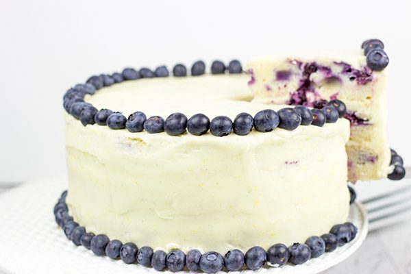 This Lemon Blueberry Cake is what happens when a muffin runs smack into the side of a cake!  Featuring muffin-like layers of cake topped with lemon cream cheese frosting, this dessert is mighty tasty!