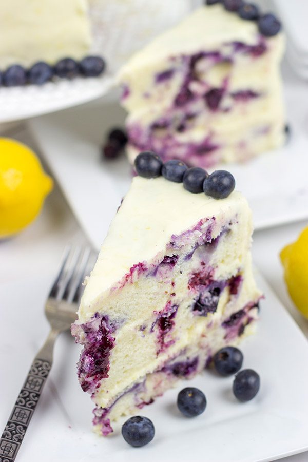 This Lemon Blueberry Cake is what happens when a muffin runs smack into the side of a cake!  Featuring muffin-like layers of cake topped with lemon cream cheese frosting, this dessert is mighty tasty!
