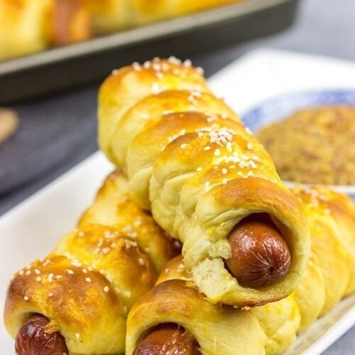 These Cheddar Pretzel Hot Dogs are wrapped with soft pretzel dough and covered with shredded cheese. Talk about a tasty way to bake up a hot dog!