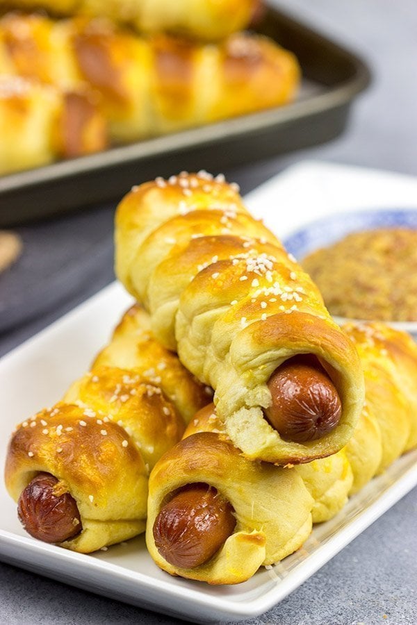 These Cheddar Pretzel Hot Dogs are wrapped with soft pretzel dough and covered with shredded cheese. Talk about a tasty way to bake up a hot dog!