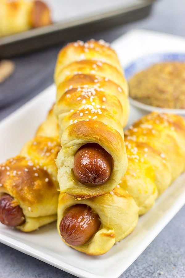 These Cheddar Pretzel Hot Dogs are wrapped with soft pretzel dough and covered with shredded cheese. Talk about a tasty way to bake up a hot dog!