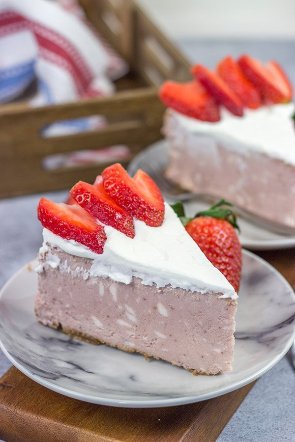 Instead of topping your cheesecake with fresh strawberries, bake 'em straight in!  This Fresh Strawberry Cheesecake is a fun dessert for warm summer days!