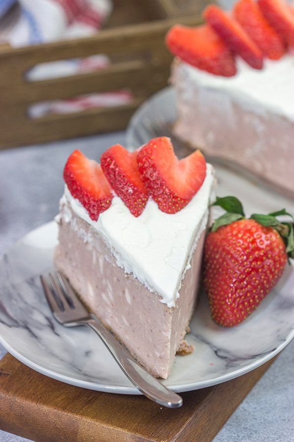 Instead of topping your cheesecake with fresh strawberries, bake 'em straight in!  This Fresh Strawberry Cheesecake is a fun dessert for warm summer days!