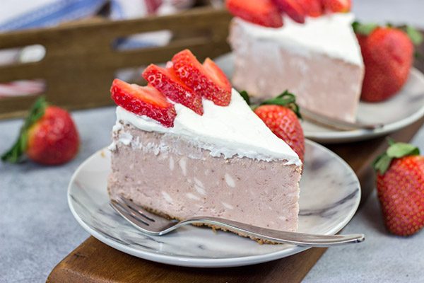 Instead of topping your cheesecake with fresh strawberries, bake 'em straight in!  This Fresh Strawberry Cheesecake is a fun dessert for warm summer days!
