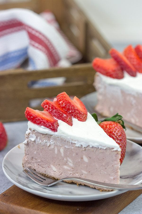 Instead of topping your cheesecake with fresh strawberries, bake 'em straight in!  This Fresh Strawberry Cheesecake is a fun dessert for warm summer days!