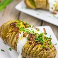 These Loaded Hasselback Baked Potatoes are a fun twist on a baked potato. Crispy edges, soft inside...and they're topped with bacon and cheese!
