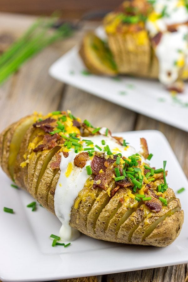 These Loaded Hasselback Baked Potatoes are a fun twist on a baked potato. Crispy edges, soft inside...and they're topped with bacon and cheese!
