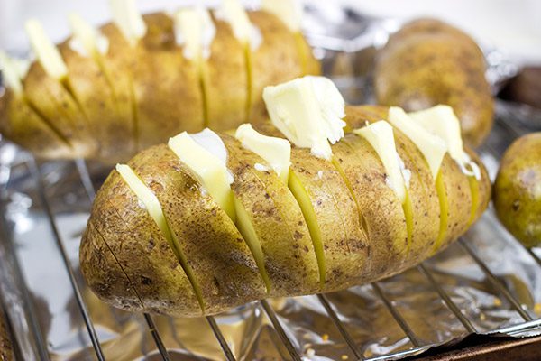 These Loaded Hasselback Baked Potatoes are a fun twist on a baked potato. Crispy edges, soft inside...and they're topped with bacon and cheese!