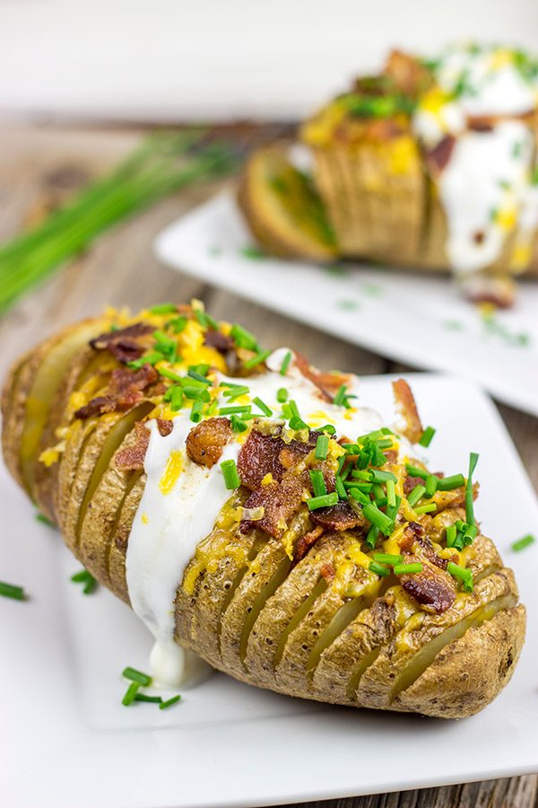 These Loaded Hasselback Baked Potatoes are a fun twist on a baked potato.  Crispy edges, soft inside...and they're topped with bacon and cheese!