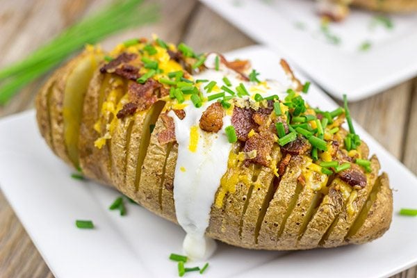 These Loaded Hasselback Baked Potatoes are a fun twist on a baked potato.  Crispy edges, soft inside...and they're topped with bacon and cheese!