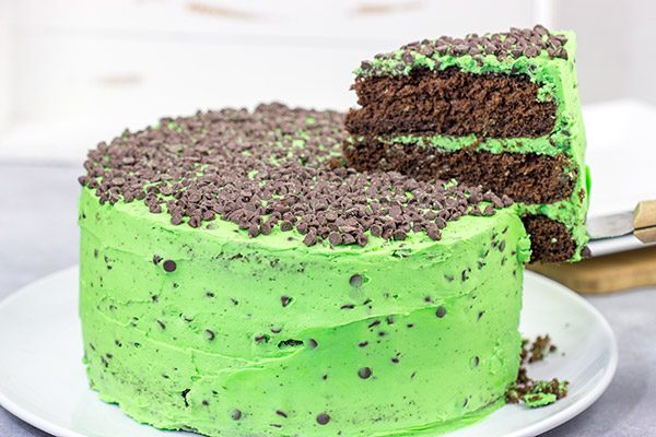 This Mint Chocolate Chip Cake features three layers of decadent chocolate cake covered by a delicious mint green frosting.  Grab a slice for dessert tonight!