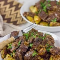 Carbonade Flamande is a traditional Belgian dish consisting of beef short ribs simmered in Belgian ale and then served over fries or roasted potatoes.  It's the perfect comfort food for cold weather!
