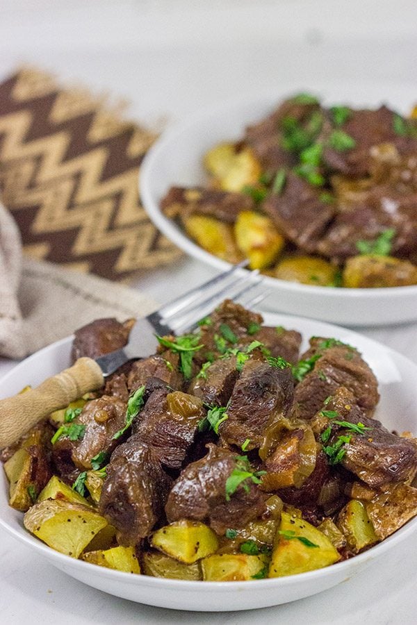 Carbonade Flamande is a traditional Belgian dish consisting of beef short ribs simmered in Belgian ale and then served over fries or roasted potatoes. It's the perfect comfort food for cold weather!
