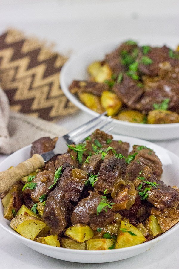 Carbonade Flamande is a traditional Belgian dish consisting of beef short ribs simmered in Belgian ale and then served over fries or roasted potatoes.  It's the perfect comfort food for cold weather!