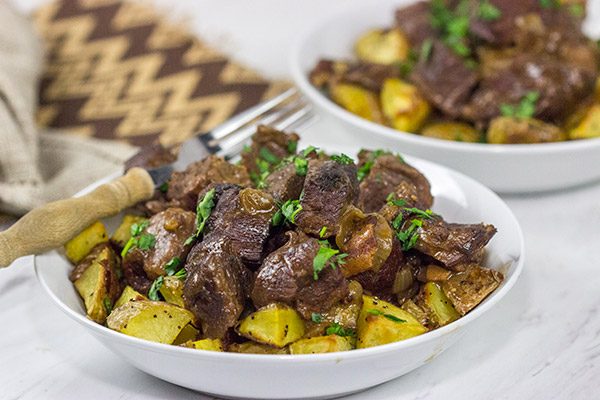 Carbonade Flamande is a traditional Belgian dish consisting of beef short ribs simmered in Belgian ale and then served over fries or roasted potatoes.  It's the perfect comfort food for cold weather!