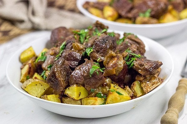 Carbonade Flamande is a traditional Belgian dish consisting of beef short ribs simmered in Belgian ale and then served over fries or roasted potatoes.  It's the perfect comfort food for cold weather!
