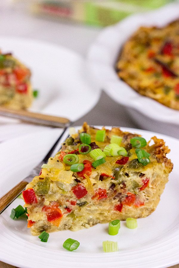 Let's do brunch the right way!  This Cheesy Quiche with Hash Brown Crust is loaded with 2 types of cheese, bacon, onions and peppers.  Yum!
