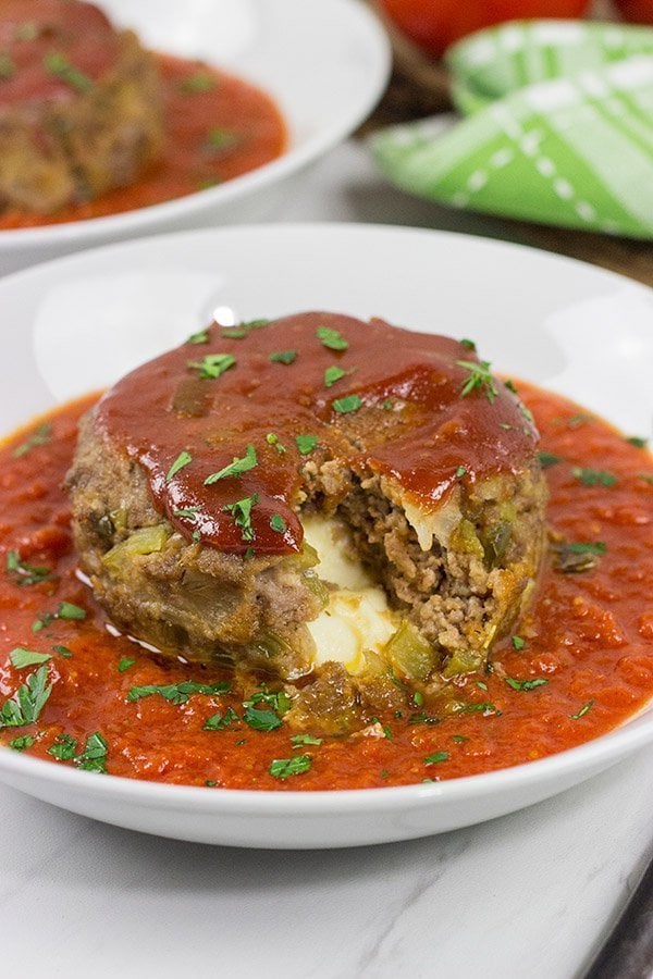 This Mozzarella-Stuffed Meatloaf is packed with comfort food flavor...and melty cheese!  This ain't your grandma's meatloaf recipe!