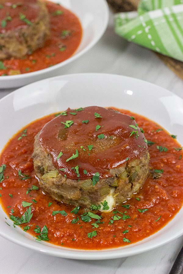 This Mozzarella-Stuffed Meatloaf is packed with comfort food flavor...and melty cheese!  This ain't your grandma's meatloaf recipe!