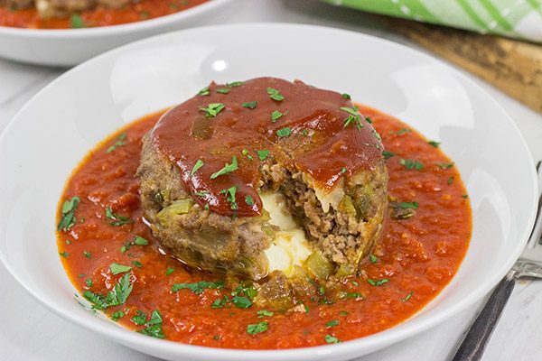 This Mozzarella-Stuffed Meatloaf is packed with comfort food flavor...and melty cheese!  This ain't your grandma's meatloaf recipe!