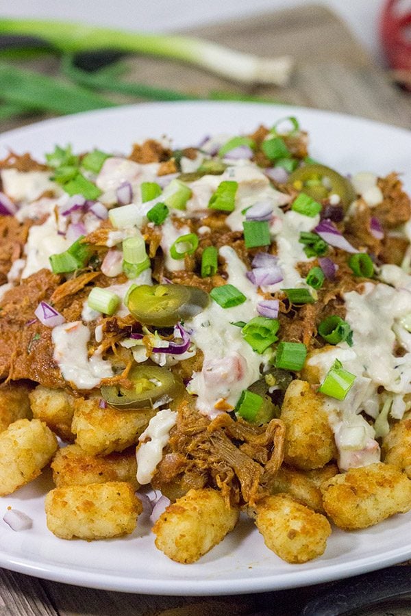 Kick off BBQ season the right way! These Pulled Pork Totchos are topped with pulled pork, cole slaw and pepper jack queso. This delicious appetizer will be the hit of the party!