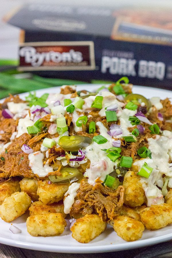 Kick off BBQ season the right way! These Pulled Pork Totchos are topped with pulled pork, cole slaw and pepper jack queso. This delicious appetizer will be the hit of the party!