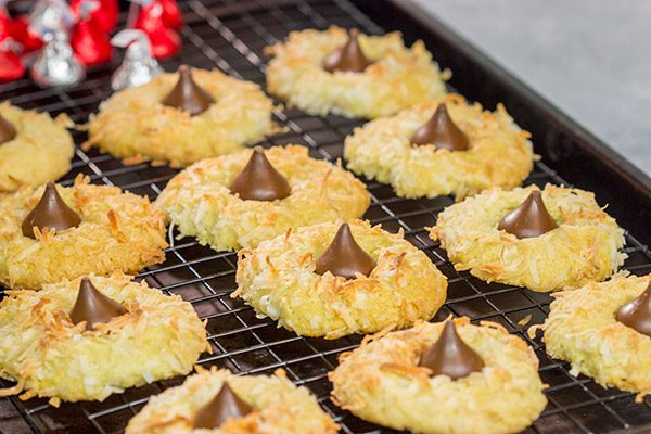 These Coconut Chocolate Kiss Cookies are a fun twist on the classic sugar cookie! Toasted coconut + melty chocolate combine for a tasty sweet treat!