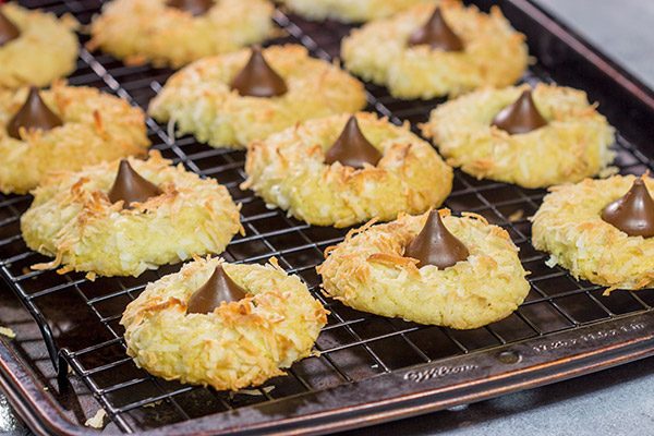 These Coconut Chocolate Kiss Cookies are a fun twist on the classic sugar cookie! Toasted coconut + melty chocolate combine for a tasty sweet treat!