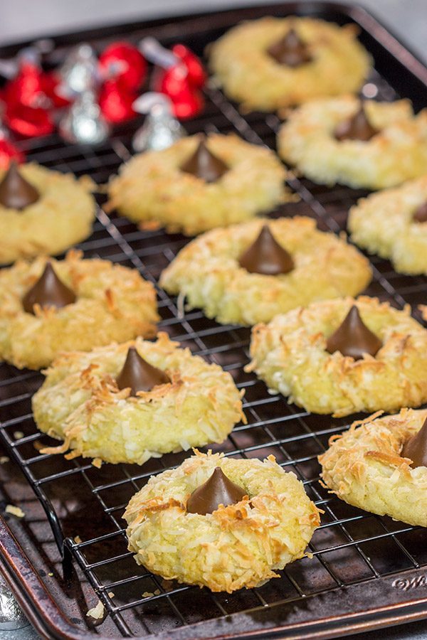 These Coconut Chocolate Kiss Cookies are a fun twist on the classic sugar cookie! Toasted coconut + melty chocolate combine for a tasty sweet treat!