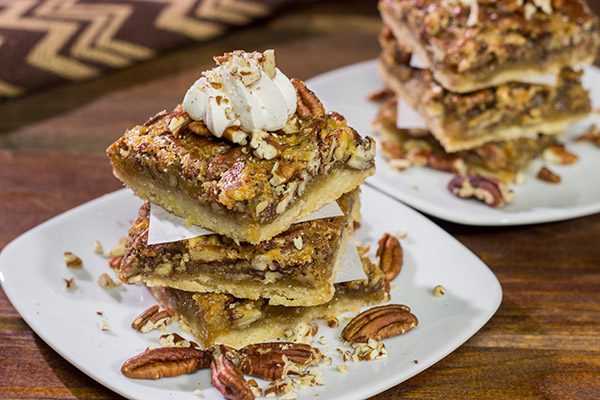 There's a reason why pecan pie is a holiday staple!  These Pecan Pie Bars feature a buttery shortbread crust topped with a gooey pecan pie filling.  They're perfect for grabbing and gobbling!