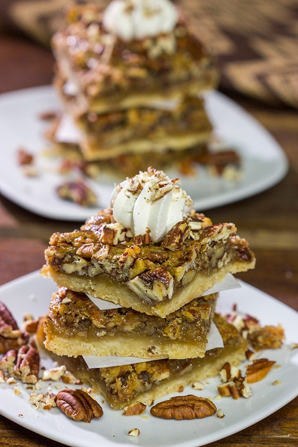 There's a reason why pecan pie is a holiday staple!  These Pecan Pie Bars feature a buttery shortbread crust topped with a gooey pecan pie filling.  They're perfect for grabbing and gobbling!