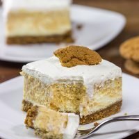 These Pumpkin Swirl Cheesecake Bars feature creamy cheesecake topped with a vanilla bean whipped cream...all over a gingersnap crust! Talk about the perfect Autumn dessert!