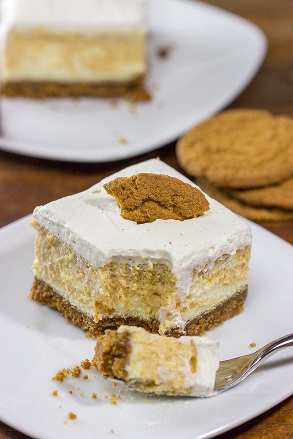 These Pumpkin Swirl Cheesecake Bars feature creamy cheesecake topped with a vanilla bean whipped cream...all over a gingersnap crust! Talk about the perfect Autumn dessert!