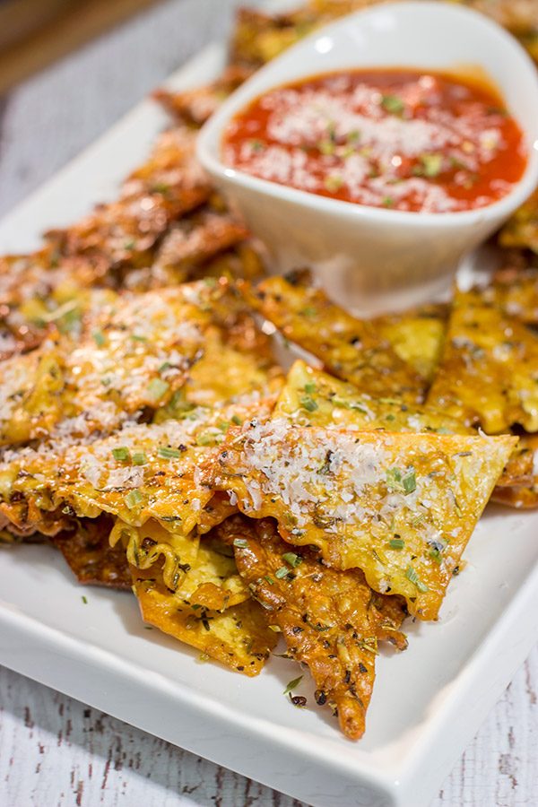 Looking for a fun snack to serve during football season?  These Italian Herb Baked Lasagna Chips are a unique (and tasty) addition to the appetizer menu!