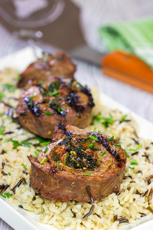 Impress your family and friends with this Grilled Stuffed Flank Steak!  Stuffed with spinach and roasted red peppers, this steak is a delicious option for the summer grill!