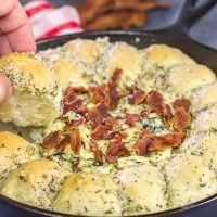 Served right out of the cast iron skillet, this Bacon Spinach Dip with Garlic Knots makes for a fun and tasty Super Bowl appetizer!
