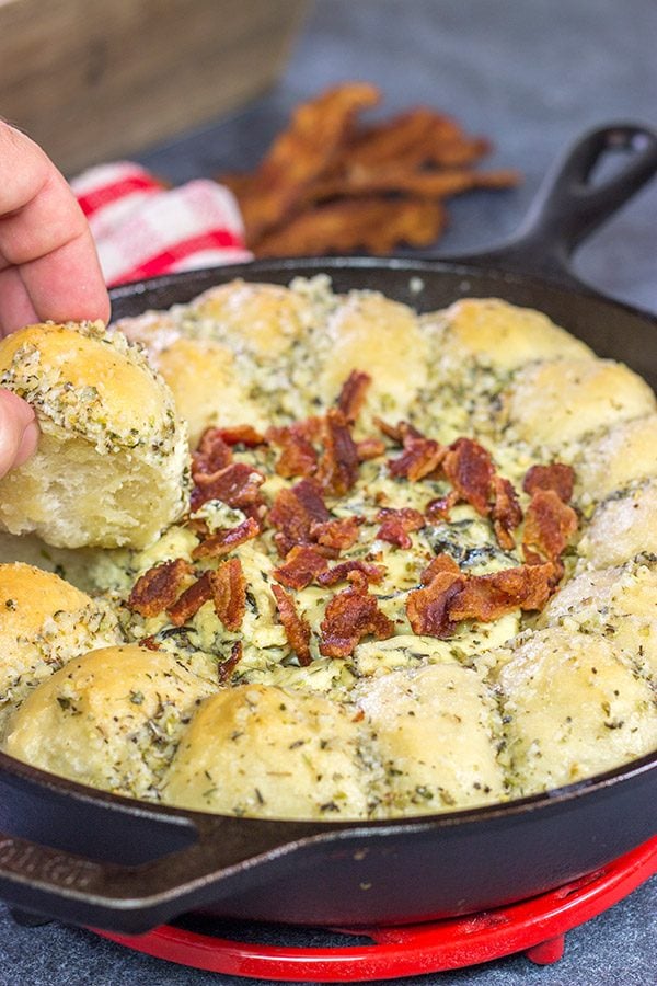 Served right out of the cast iron skillet, this Bacon Spinach Dip with Garlic Knots makes for a fun and tasty Super Bowl appetizer!