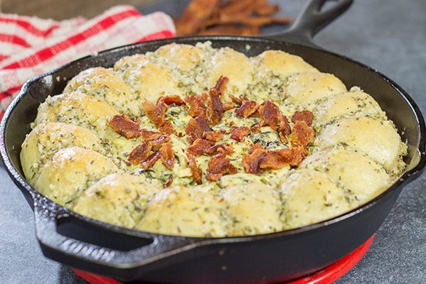 Served right out of the cast iron skillet, this Bacon Spinach Dip with Garlic Knots makes for a fun and tasty Super Bowl appetizer!