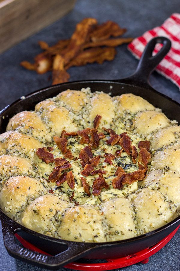 Served right out of the cast iron skillet, this Bacon Spinach Dip with Garlic Knots makes for a fun and tasty Super Bowl appetizer!