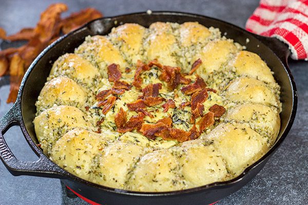 Served right out of the cast iron skillet, this Bacon Spinach Dip with Garlic Knots makes for a fun and tasty Super Bowl appetizer!