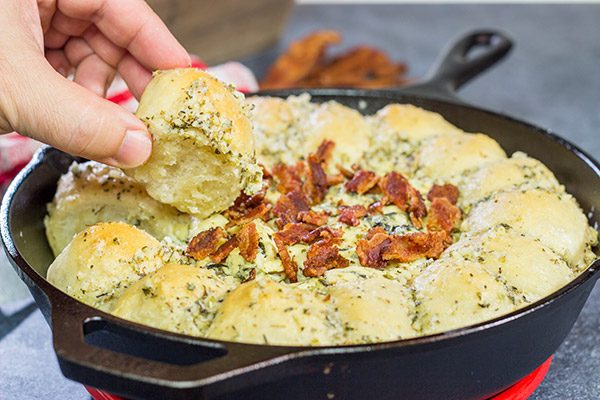 Served right out of the cast iron skillet, this Bacon Spinach Dip with Garlic Knots makes for a fun and tasty Super Bowl appetizer!