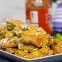 Baked crispy chicken wings. That's right. Baked! These Blue Heat Baked Chicken Wings feature a tasty combination of buffalo sauce and homemade blue cheese dressing.