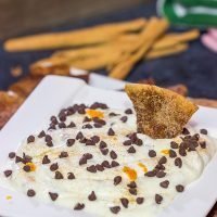 Don't forget the sweet treats on your appetizer table! This Cannoli Dip with Cinnamon Sugar Pita Chips takes almost no time to make. It's sure to be a party favorite!