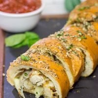 This Chicken Parm Stuffed Garlic Bread is 2 comfort food favorites in 1! Crispy chicken and melty cheese stuffed inside garlicky, buttery bread. Pass me a slice!